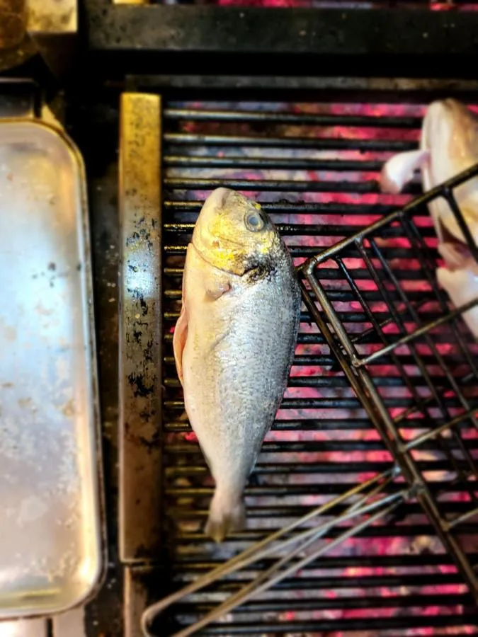 a fish on a rack on a grill at Parador 44 in Cardiff